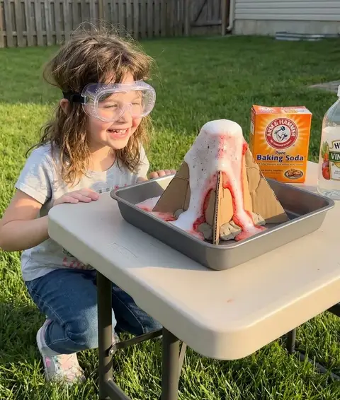 Homeschool science experiment - child doing volcano project with baking soda